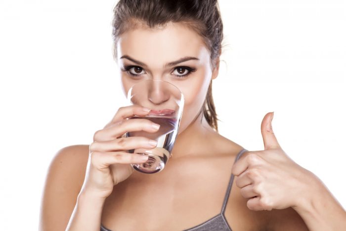 woman-drinking-water-gives-thumbs-up